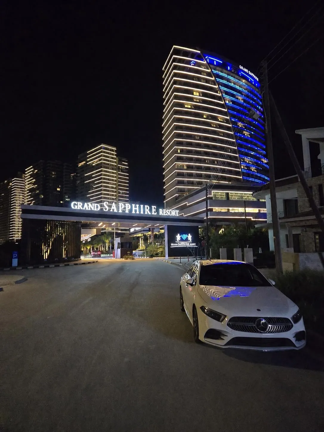 Grand Sapphire Resort in Iskele bei Nacht — beleuchteter Hochhaus-Komplex mit blauen Akzentlichtern, Nordzypern